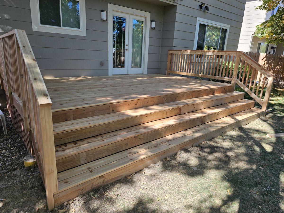 New cedar deck with wide wraparound stairs and railings